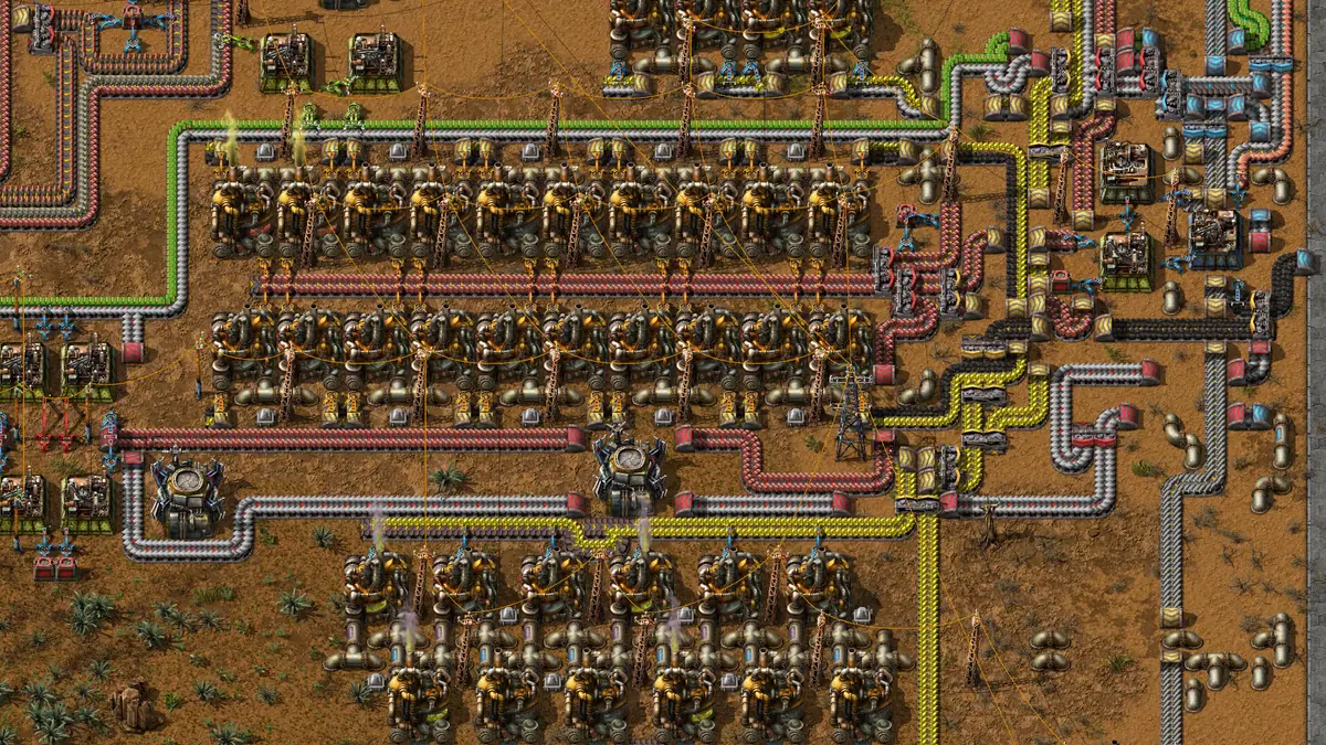 Factorio mid-game factory base with rail network and assemblers